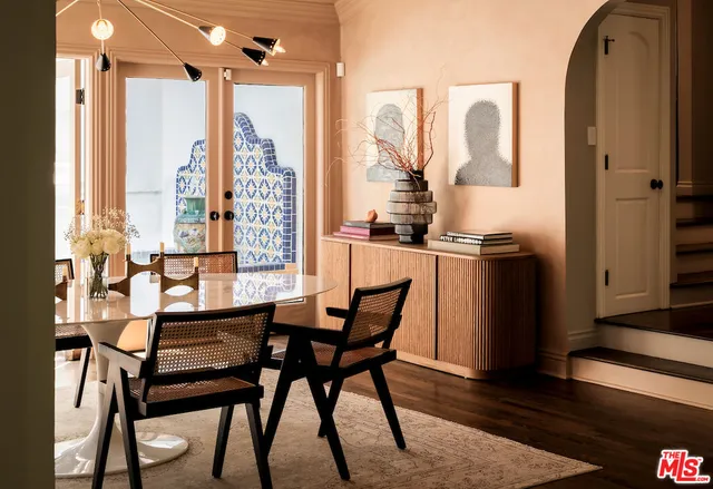 a dining room with furniture and wooden floor