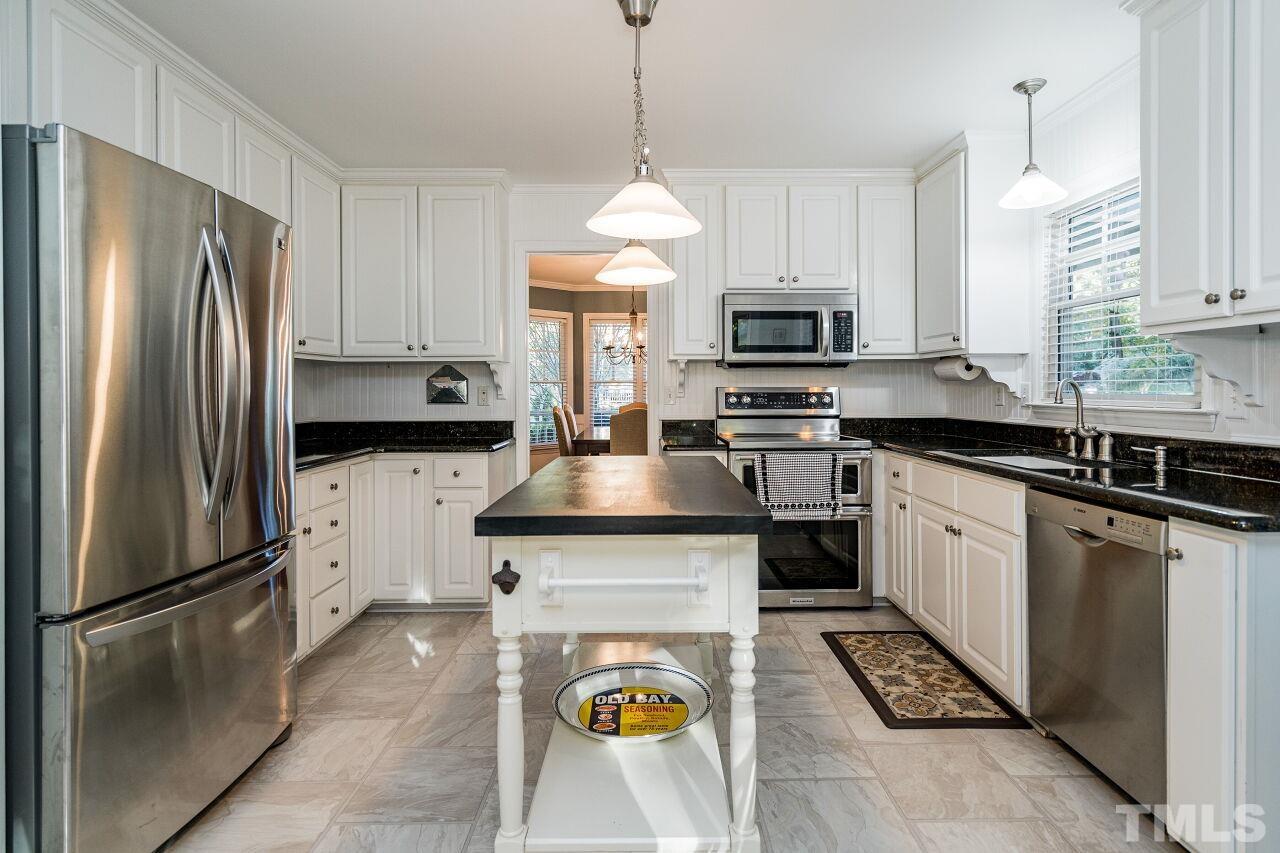2201 Dunlin Lane Raleigh, NC 27614 - Photo 11 of 30 a kitchen with refrigerator a stove a sink and a refrigerator