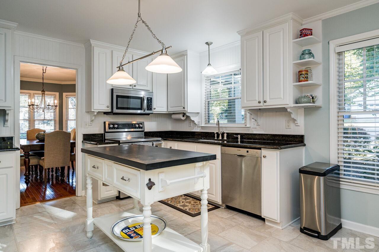 2201 Dunlin Lane Raleigh, NC 27614 - Photo 12 of 30 a kitchen with stainless steel appliances granite countertop a sink a stove and a refrigerator