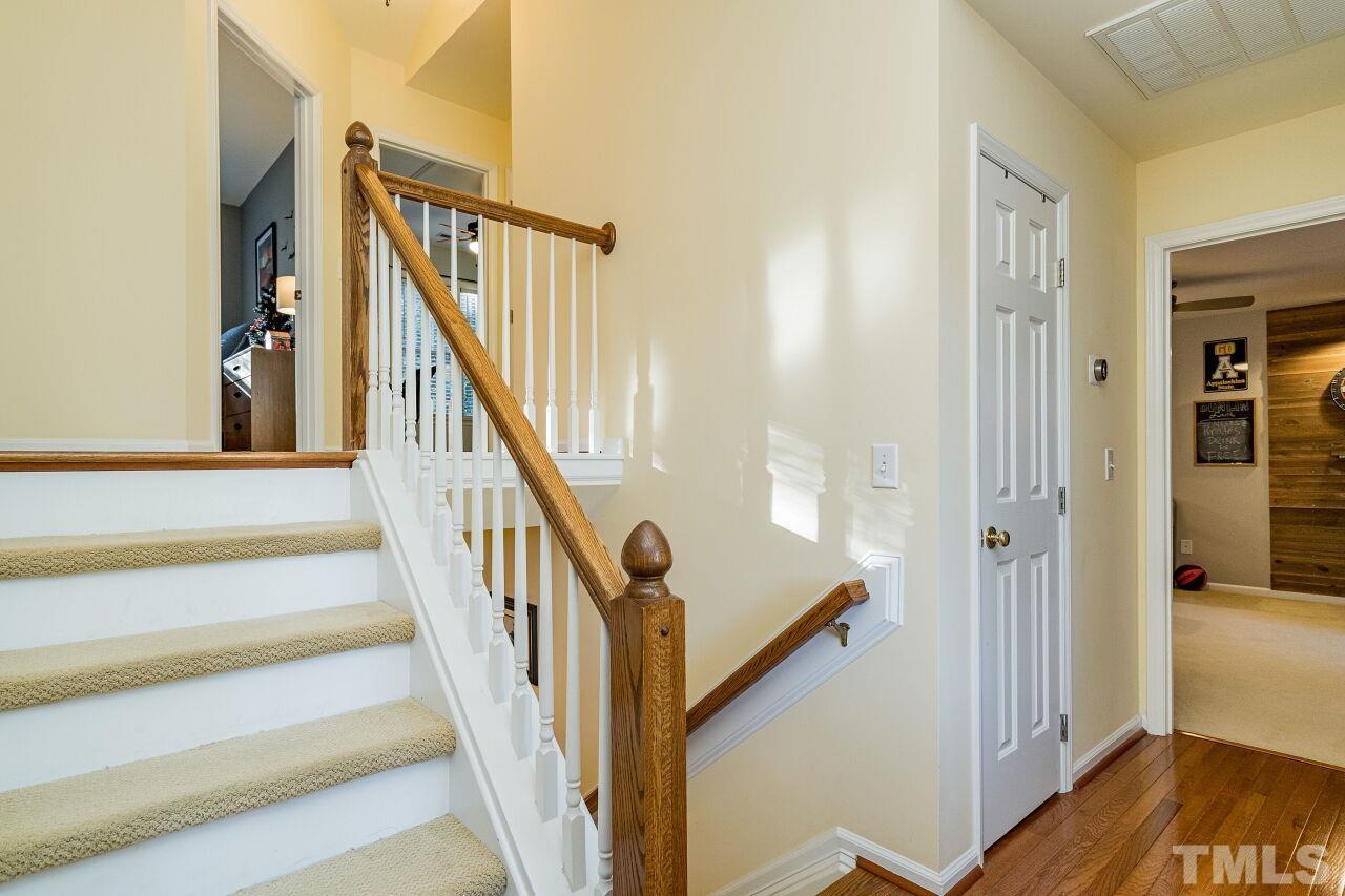 2201 Dunlin Lane Raleigh, NC 27614 - Photo 15 of 30 a view of staircase with wooden floor and a chandelier