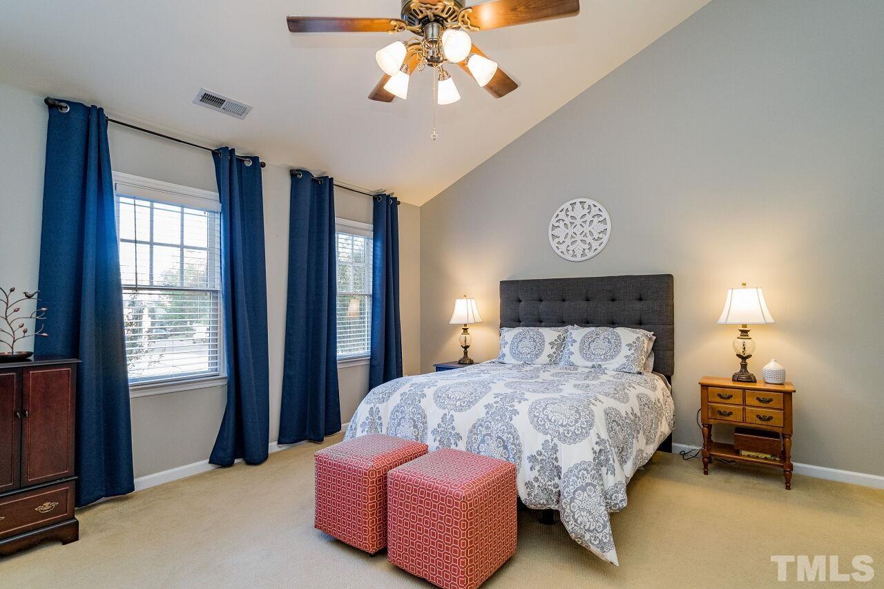 2201 Dunlin Lane Raleigh, NC 27614 - Photo 16 of 30 a bedroom with a bed and a chandelier