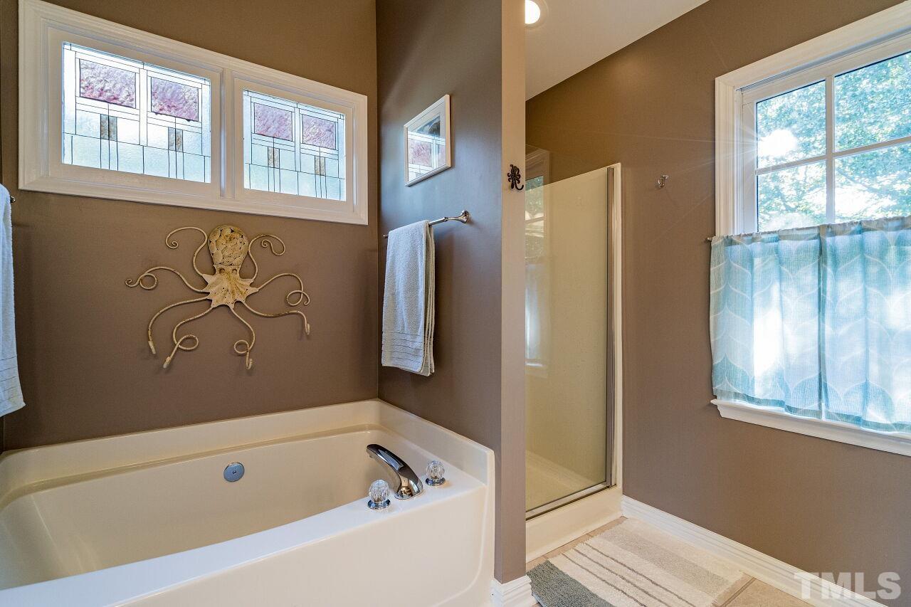 2201 Dunlin Lane Raleigh, NC 27614 - Photo 18 of 30 a bathroom with a tub and a window