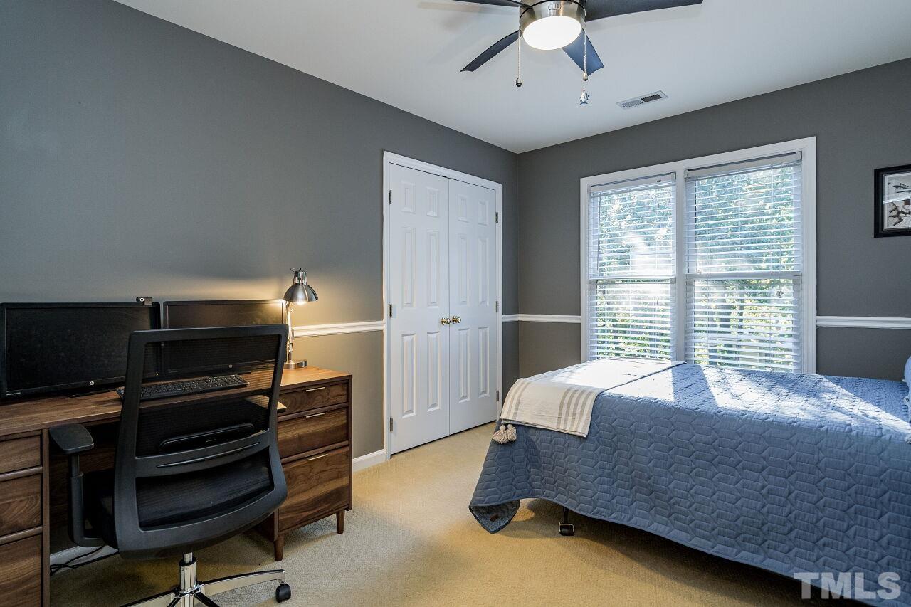 2201 Dunlin Lane Raleigh, NC 27614 - Photo 19 of 30 a bedroom with a bed closet and flat screen tv