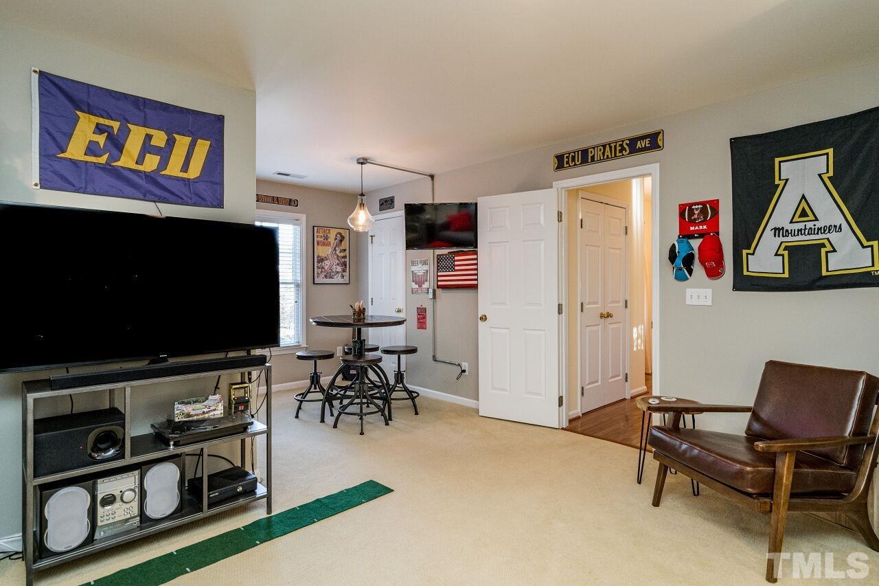 2201 Dunlin Lane Raleigh, NC 27614 - Photo 23 of 30 a living room with furniture and a flat screen tv