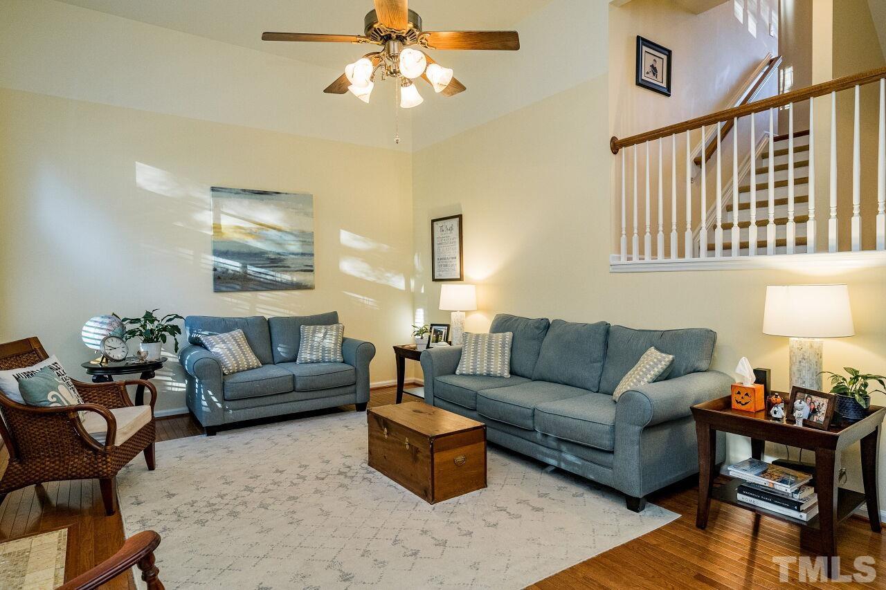2201 Dunlin Lane Raleigh, NC 27614 - Photo 5 of 30 a living room with furniture a chandelier and a window