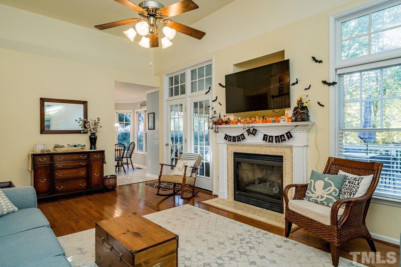 2201 Dunlin Lane Raleigh, NC 27614 - Photo 7 of 30 a living room with furniture a flat screen tv and a fireplace