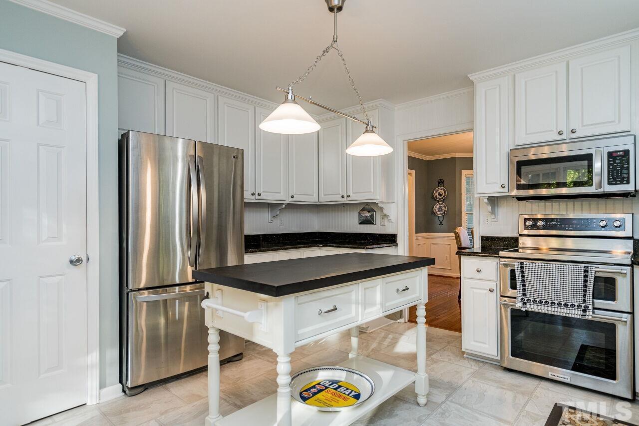 2201 Dunlin Lane Raleigh, NC 27614 - Photo 10 of 30 a kitchen with stainless steel appliances a stove a refrigerator and a microwave