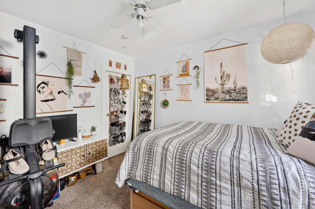 1530 East Appleton Street Long Beach, CA 90802 - Photo 10 of 61 a bedroom with a bed and a chandelier