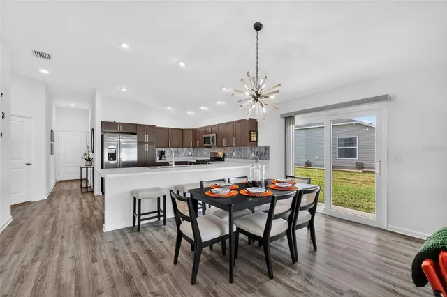 a dining room with furniture and wooden floor