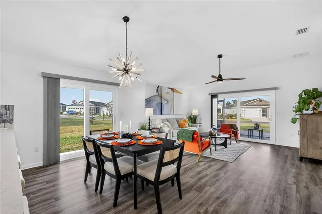 a dining room with furniture wooden floor a chandelier
