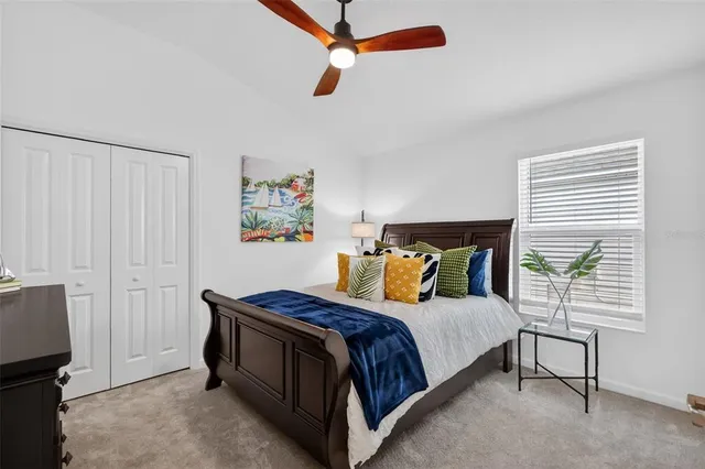 a bedroom with a bed and painting on the wall