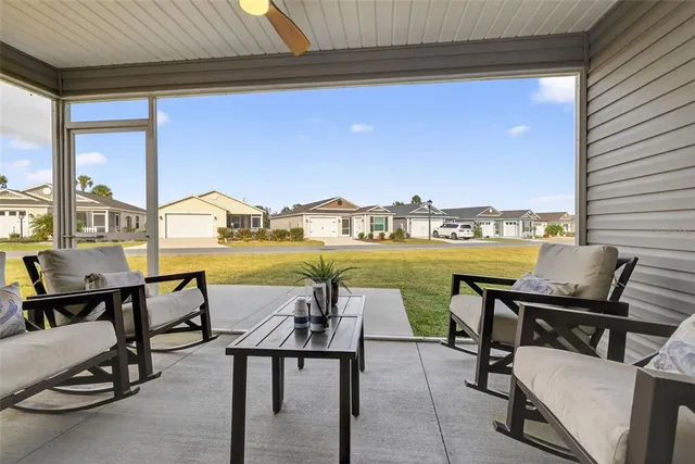 a view of swimming pool with outdoor seating and city view