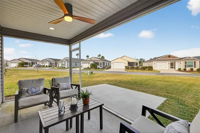 a living room with furniture and a floor to ceiling window