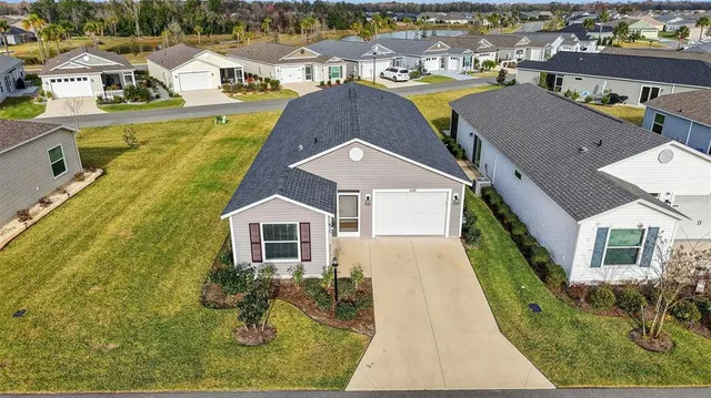 an aerial view of a house with pool and ocean view