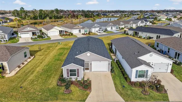 a view of residential houses with swimming pool and ocean view