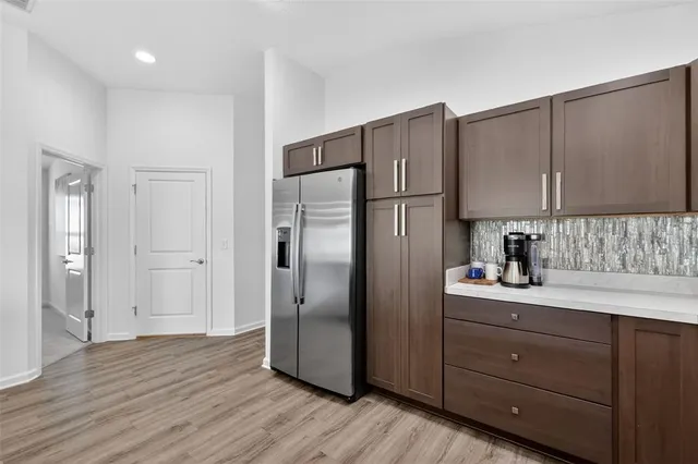 a kitchen with a refrigerator and a sink