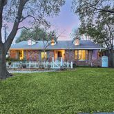 a view of a house with a yard and porch