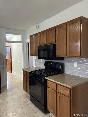 a kitchen with stainless steel appliances a stove microwave and refrigerator