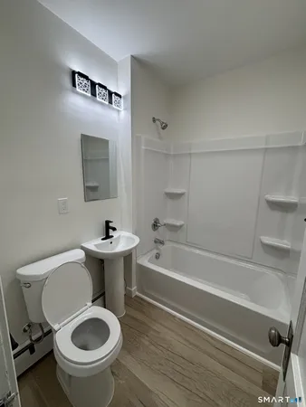 a bathroom with a sink a toilet and bathtub