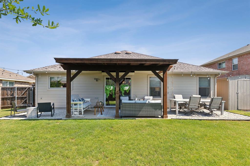 a backyard of a house with table and chairs