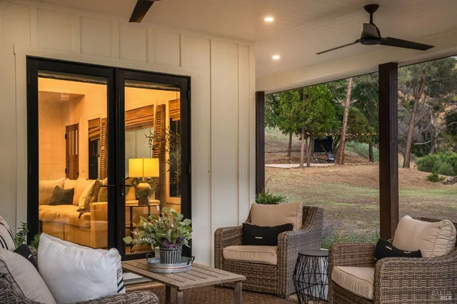 a living room with furniture and a floor to ceiling window