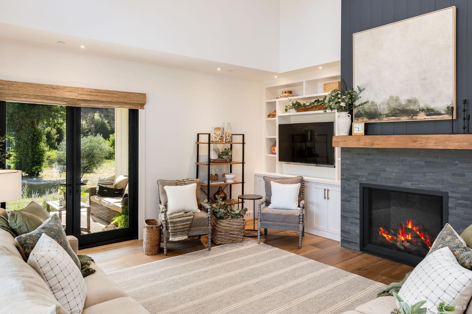 5400 Wragg Canyon Road Napa, CA 94558 - Photo 18 of 68 a living room with furniture a fireplace and a flat screen tv