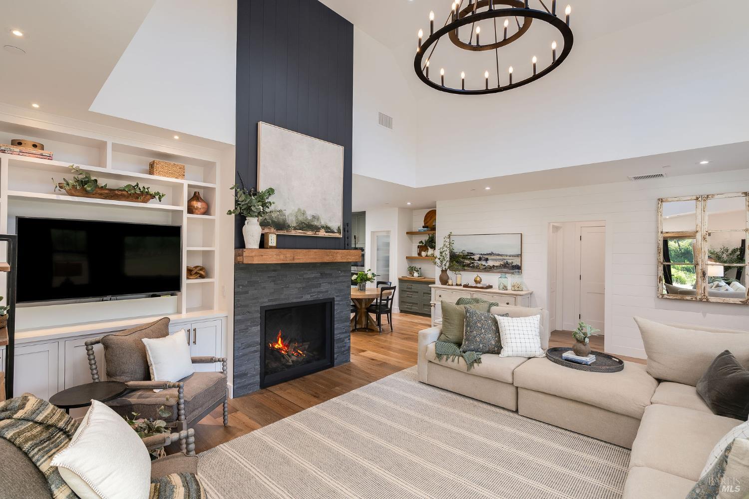 5400 Wragg Canyon Road Napa, CA 94558 - Photo 19 of 68 a living room with furniture a flat screen tv and a fireplace