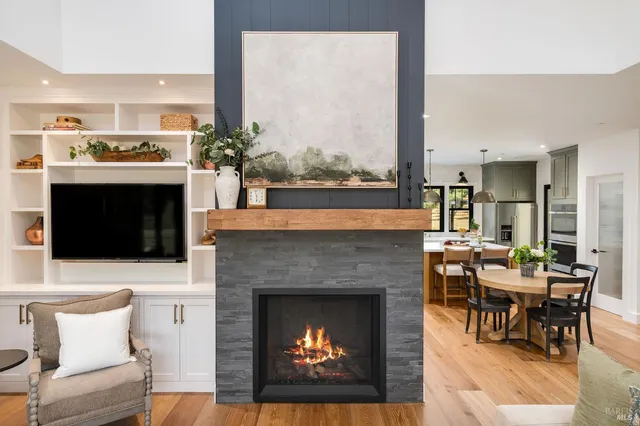 a kitchen with stainless steel appliances a sink a stove a refrigerator a center island and cabinets