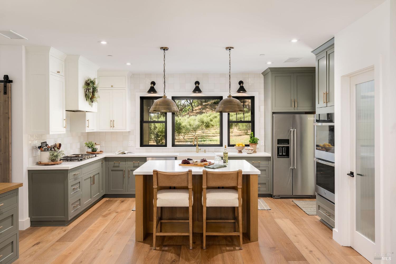 5400 Wragg Canyon Road Napa, CA 94558 - Photo 23 of 68 a kitchen with stainless steel appliances granite countertop a stove top oven a refrigerator a sink and chairs