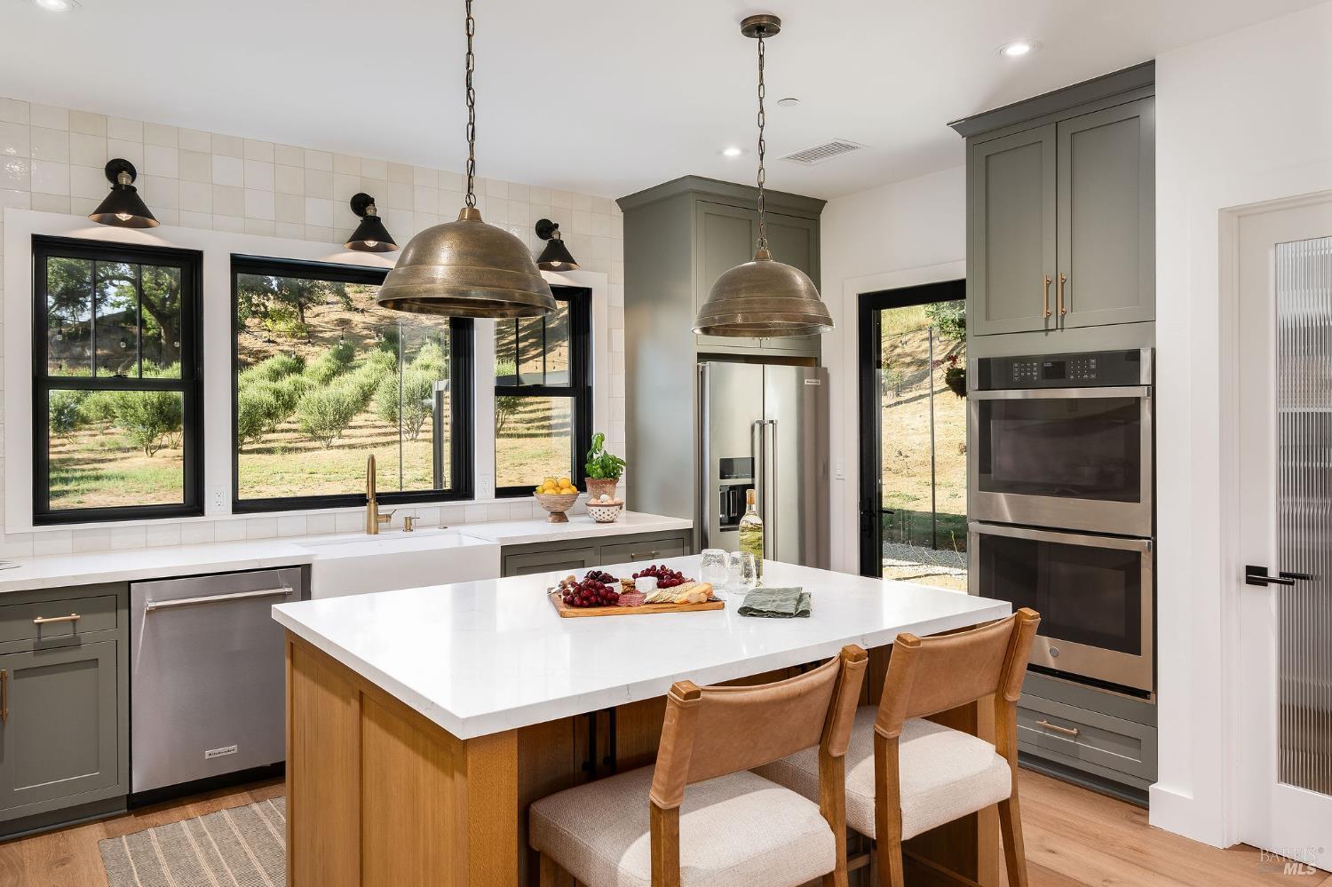 5400 Wragg Canyon Road Napa, CA 94558 - Photo 24 of 68 a open kitchen with stainless steel appliances granite countertop a stove a refrigerator a kitchen island a stove and a cabinets