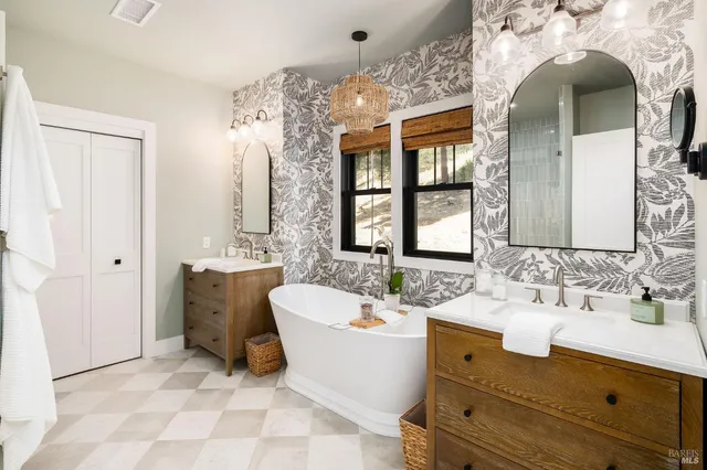 a room with a chair and white cabinets