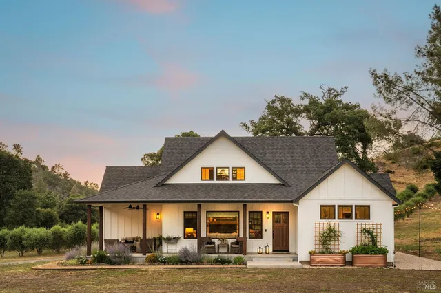 a living room with fireplace furniture and a wooden floor