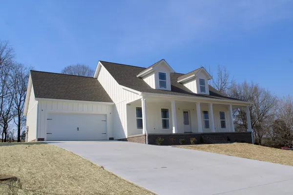 a front view of a house with a yard and garage