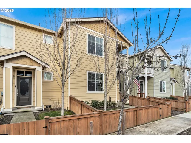 a view of a house with wooden fence