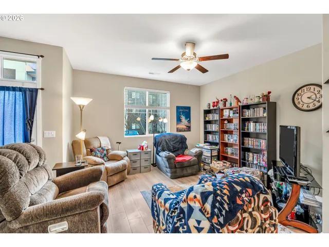 a living room with furniture a window and a flat screen tv