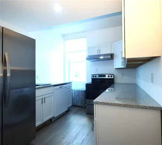 a kitchen with a sink a stove and a refrigerator