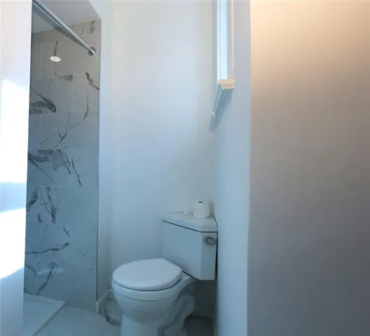 a white toilet sitting next to a bathroom sink