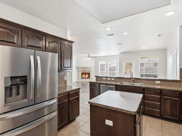 a kitchen with a sink stove and refrigerator