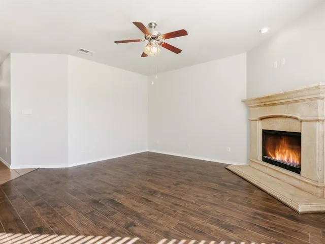a view of an empty room with a fireplace