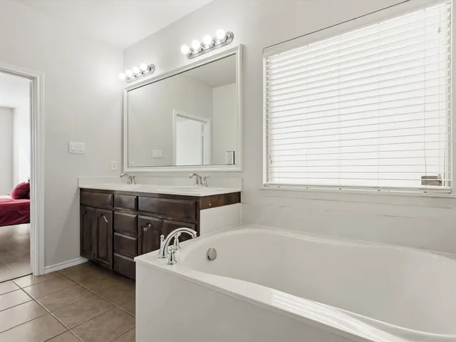 a bathroom with a bathtub and a sink