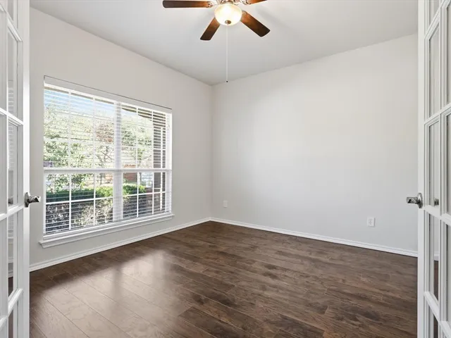 wooden floor in an empty room with a window