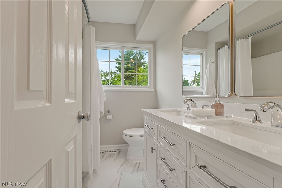 646 Ledge Road Macedonia, OH 44056 - Photo 9 of 28 Double vanity with integrated sinks, chrome fixtures, and a light-toned countertop