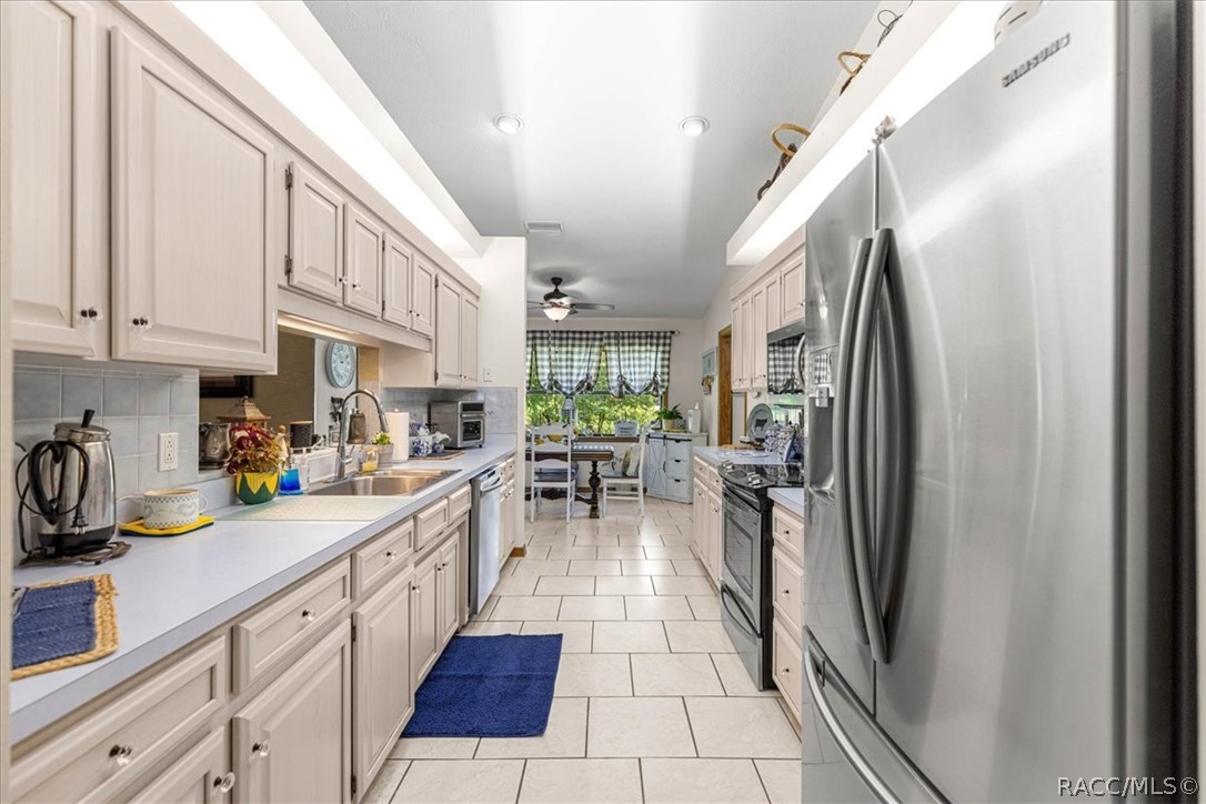 2964 South Cygnet Terrace Inverness, FL 34450 - Photo 16 of 67 a kitchen with stainless steel appliances granite countertop a refrigerator and a sink