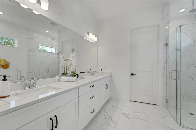 a bathroom with double sink and a mirror