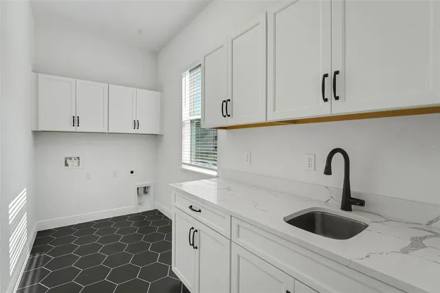 a kitchen with granite countertop a sink and cabinets