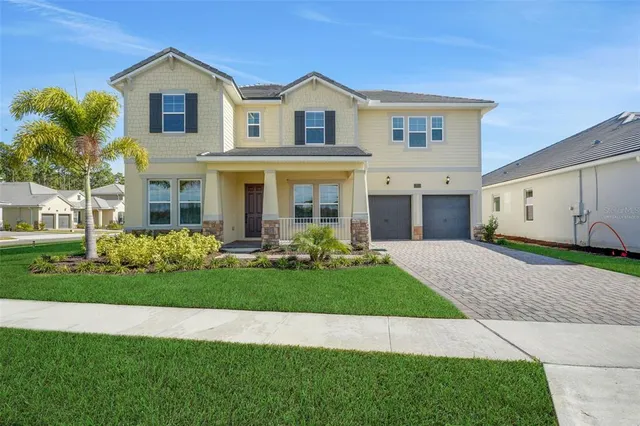 a front view of a house with a yard and garage