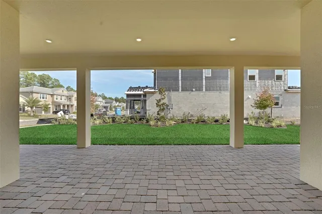 a view of a big room with wooden floor and a bathroom