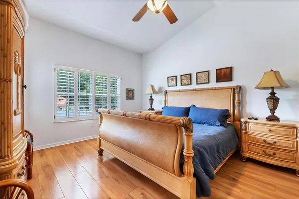a bedroom with a bed and wooden floor