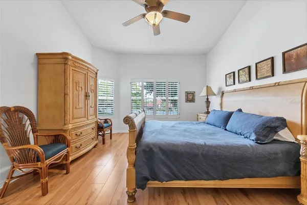 a bedroom with a bed and wooden floor