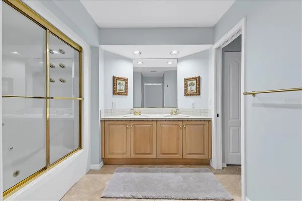 a bathroom with a granite countertop sink mirror and shower